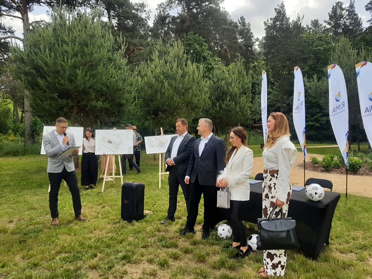 Konferencja prasowa przy ulicy Polnej w Rumi — burmistrz, wiceburmistrz i przedstawicielki firm przy sztalugach z planami trzech inwestycji sportowych
