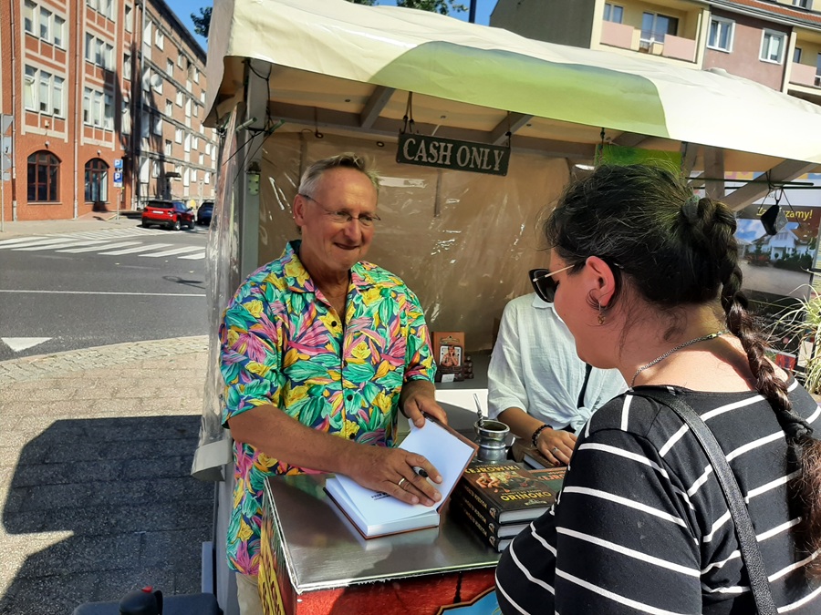 Wojciech Cejrowski podpisujący książkę czytelniczce na Jarmarku Dominikańskim
